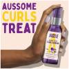 A picture of curl serum bottle held in hand with a text above: aussome curls treat.