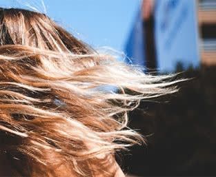 Picture of a woman with blonde hair spinning around