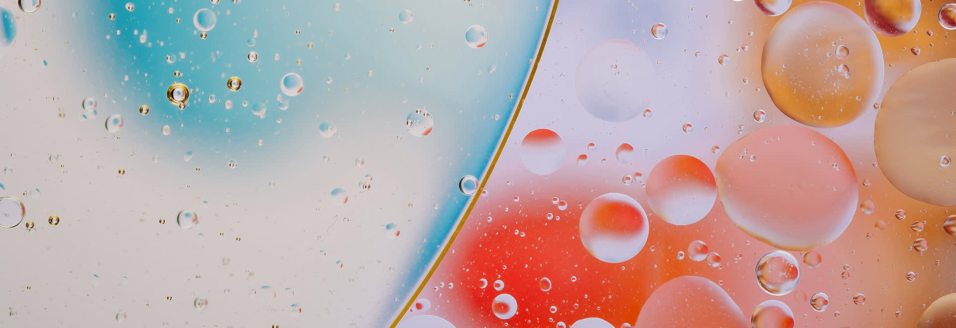 A picture of a colourful surface with water drops on it