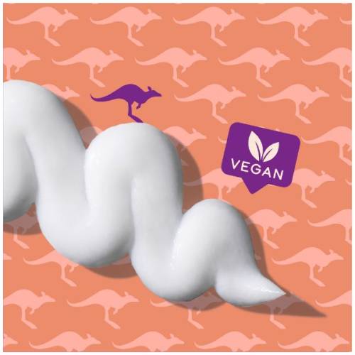 A picture of splash of conditioner and badge saying vegan. 